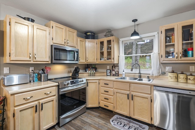 kitchen with pendant lighting, light brown cabinetry, sink, dark hardwood / wood-style floors, and appliances with stainless steel finishes