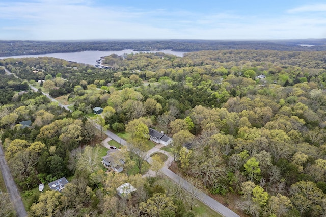 aerial view with a forest view and a water view