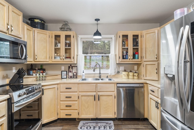 kitchen featuring pendant lighting, sink, dark wood-type flooring, appliances with stainless steel finishes, and light brown cabinetry