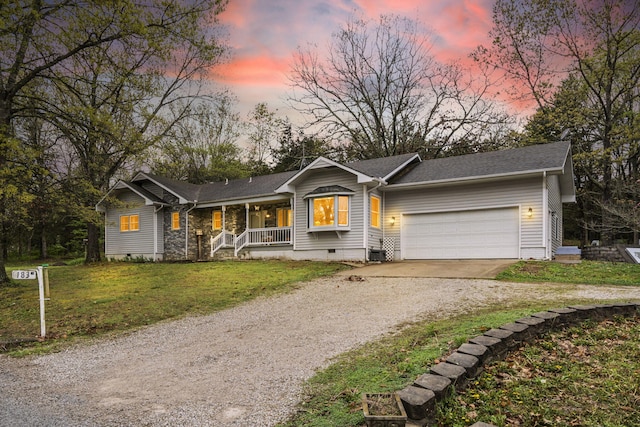 ranch-style house featuring crawl space, dirt driveway, a porch, a yard, and a garage