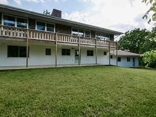 back of property featuring a lawn