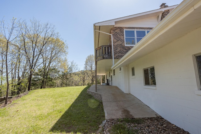 view of yard featuring a patio and a balcony