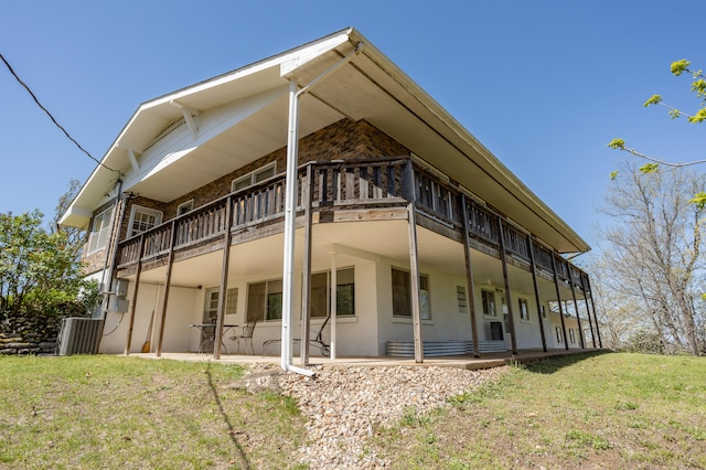 back of property featuring a yard and a patio area