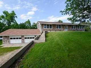 view of front of home with a garage and a front lawn