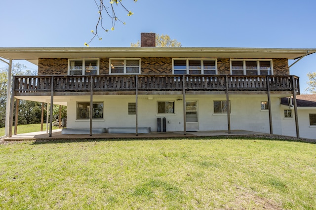 back of property featuring a lawn and a patio area