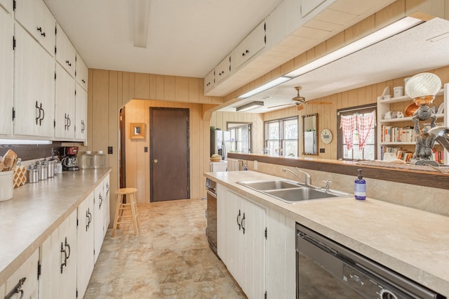 kitchen with black dishwasher, white cabinets, and sink