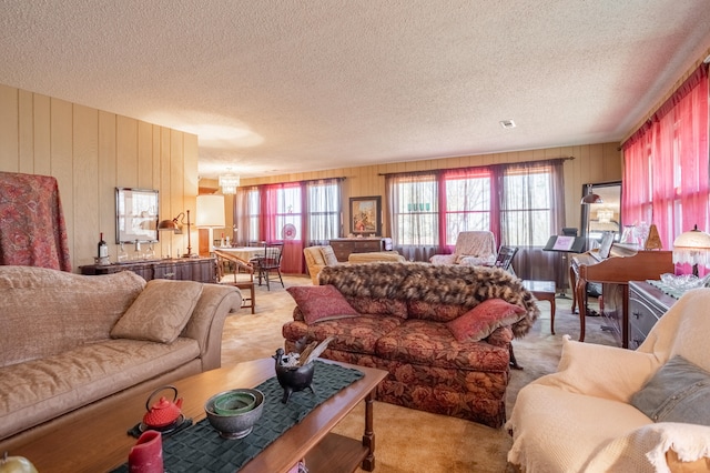 carpeted living room with a textured ceiling and wooden walls