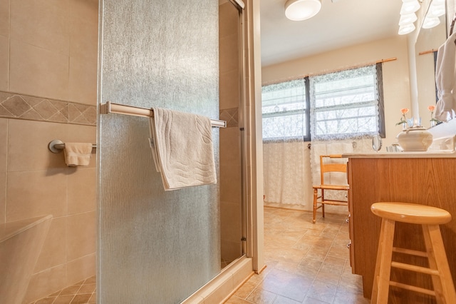 bathroom featuring vanity and an enclosed shower