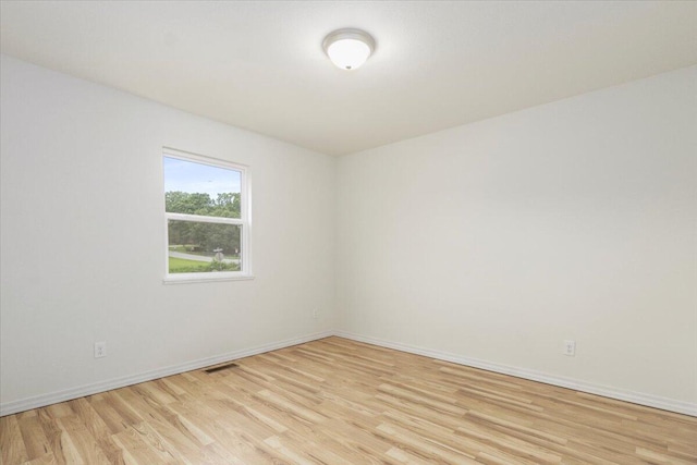 spare room featuring light wood-type flooring