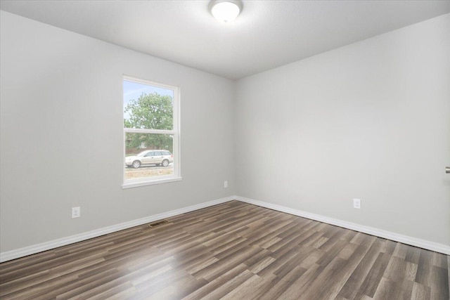 unfurnished room featuring dark hardwood / wood-style flooring