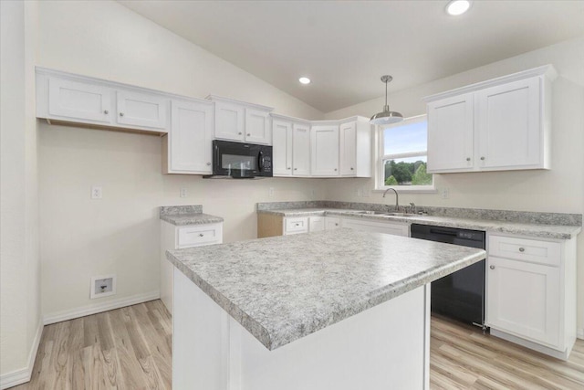 kitchen featuring white cabinets, a kitchen island, vaulted ceiling, and black appliances