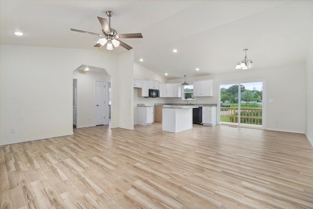 unfurnished living room featuring ceiling fan with notable chandelier, light wood-type flooring, high vaulted ceiling, and sink