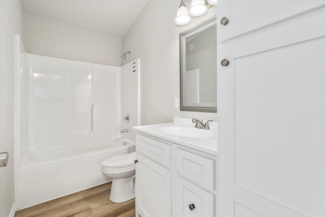 full bathroom featuring vanity, hardwood / wood-style flooring, shower / washtub combination, and toilet