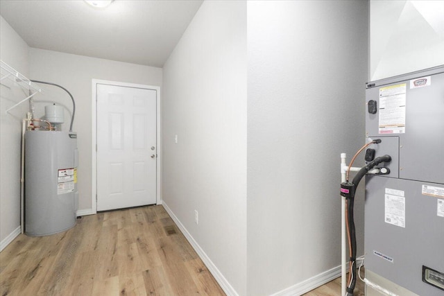 utility room featuring water heater and heating unit