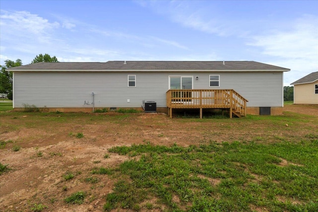 rear view of house featuring cooling unit and a wooden deck