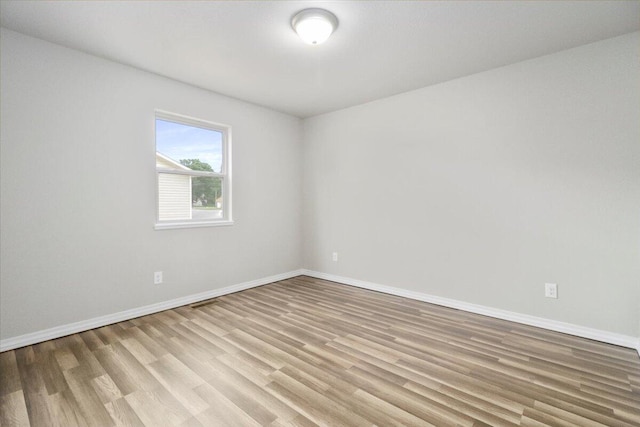 spare room featuring light wood-type flooring