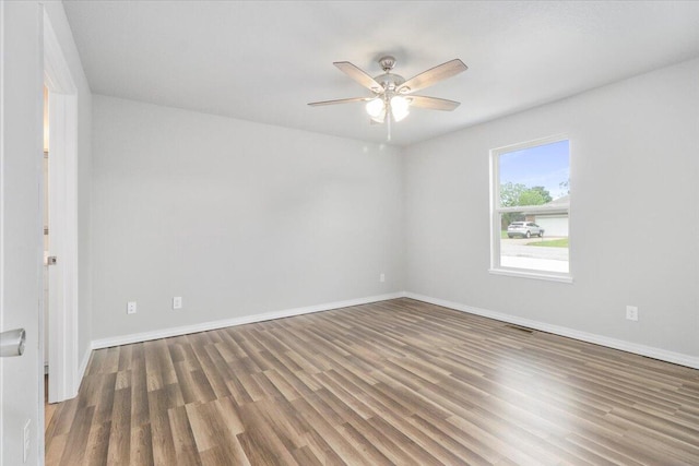 spare room featuring dark hardwood / wood-style floors and ceiling fan