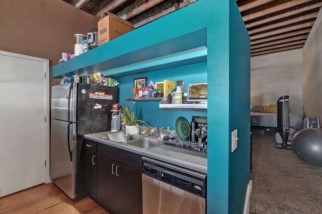 kitchen with sink, stainless steel appliances, dark brown cabinetry, beam ceiling, and light hardwood / wood-style flooring