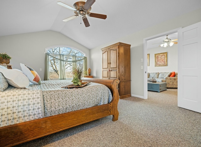 bedroom featuring vaulted ceiling, light colored carpet, and ceiling fan