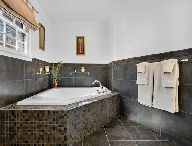 bathroom featuring tile patterned floors, tiled bath, and tile walls