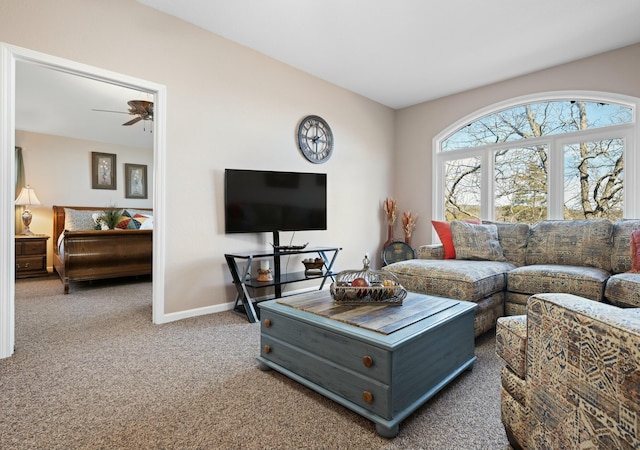 carpeted living room featuring ceiling fan