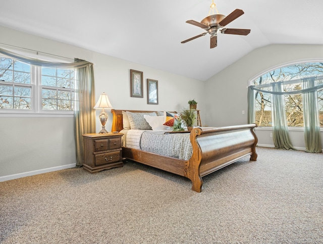 carpeted bedroom with multiple windows, vaulted ceiling, and ceiling fan