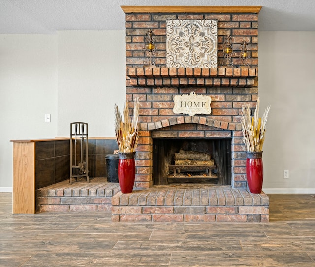 room details with wood-type flooring, a fireplace, and a textured ceiling