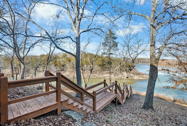 wooden terrace featuring a water view