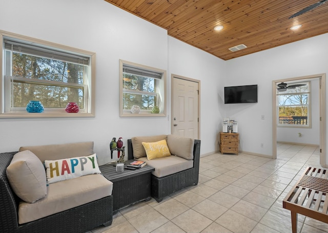 living room featuring light tile patterned floors and wood ceiling