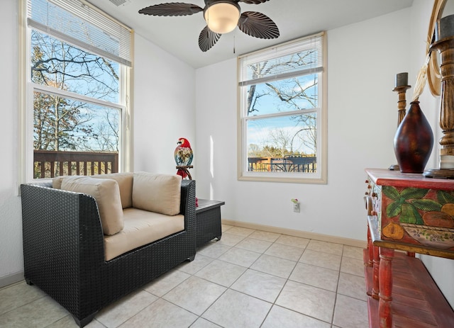 sitting room with light tile patterned floors and ceiling fan