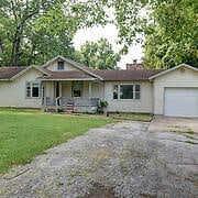 view of front of home with a garage and a front lawn