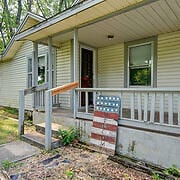 view of exterior entry with covered porch