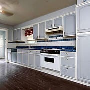 kitchen featuring dark wood-type flooring, decorative backsplash, and white stove