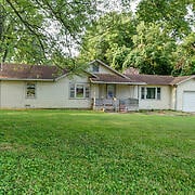 view of front of home with a garage and a front lawn