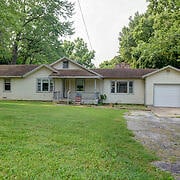 single story home featuring a front lawn and a garage