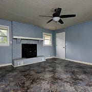 unfurnished living room with plenty of natural light and ceiling fan