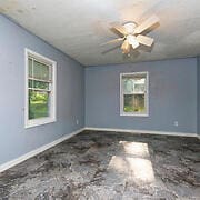 unfurnished room featuring ceiling fan