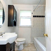 full bathroom featuring toilet, tile patterned flooring, vanity, and tiled shower / bath combo