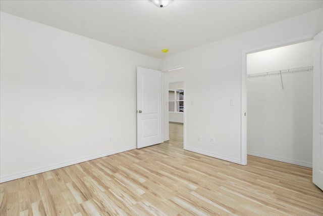 unfurnished bedroom featuring a closet and light hardwood / wood-style flooring