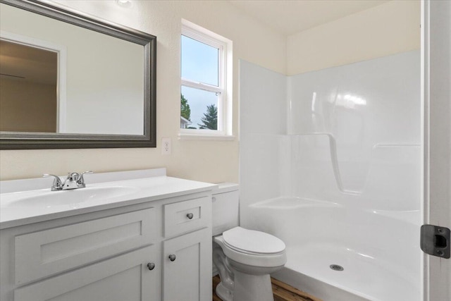 bathroom featuring hardwood / wood-style flooring, vanity, toilet, and a shower