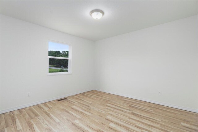 unfurnished room with light hardwood / wood-style flooring