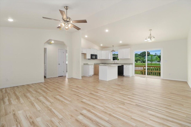 unfurnished living room featuring ceiling fan with notable chandelier, high vaulted ceiling, sink, and light hardwood / wood-style floors