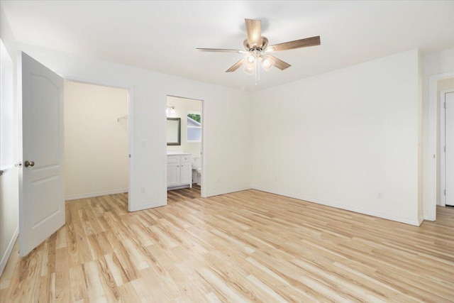 unfurnished bedroom with ensuite bathroom, ceiling fan, a closet, and light hardwood / wood-style flooring