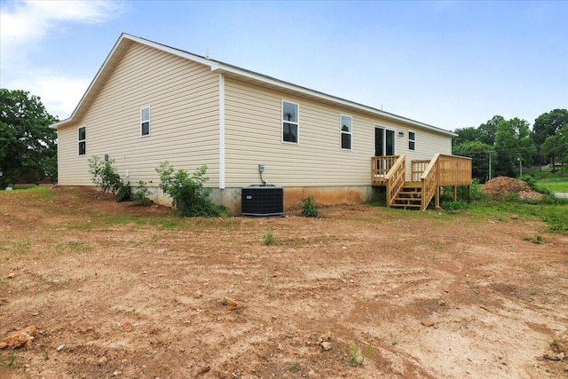 rear view of house featuring cooling unit and a deck