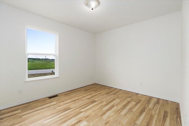 empty room with light hardwood / wood-style flooring