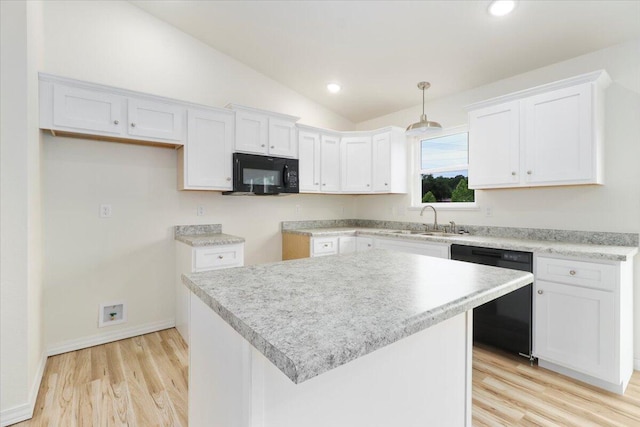 kitchen with vaulted ceiling, a center island, white cabinetry, and black appliances