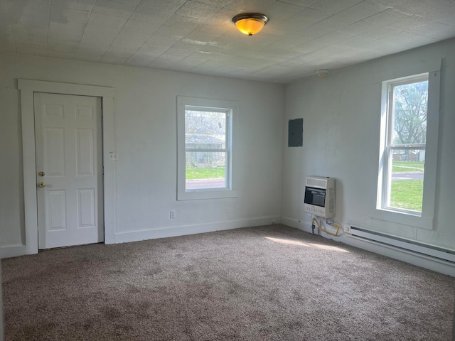 carpeted empty room with heating unit, a baseboard radiator, and a healthy amount of sunlight