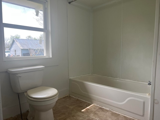 bathroom with tub / shower combination and toilet