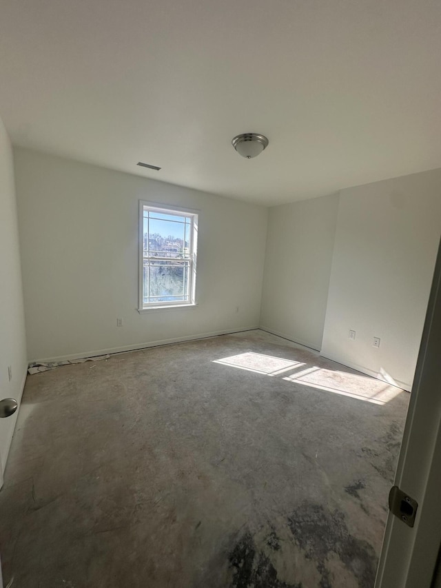 empty room with concrete flooring