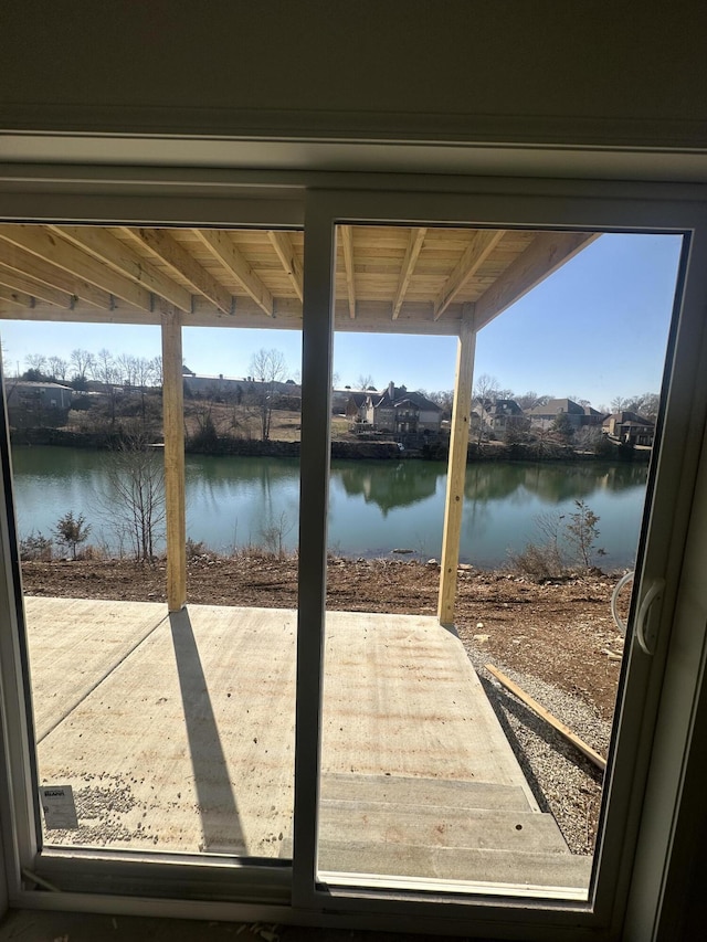 dock area with a water view and a patio